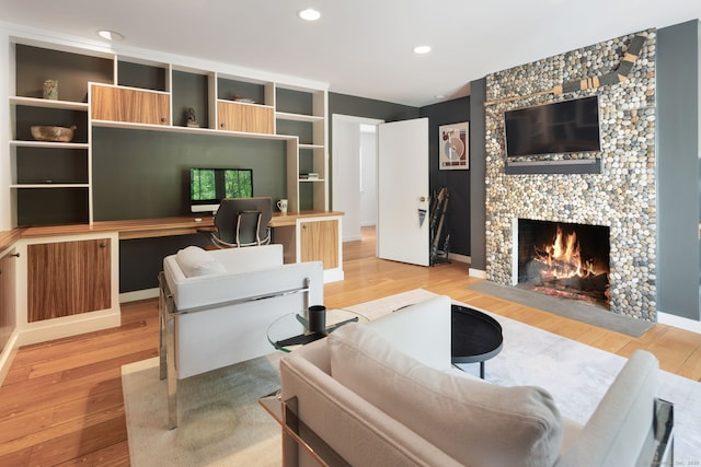 1580 Ponus Rdg, New Canaan, CT 06840 - living area featuring light wood-style flooring, a tiled fireplace, and recessed lighting