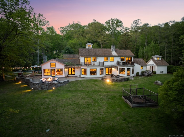 1580 Ponus Rdg, New Canaan, CT 06840 - rear view of property featuring a patio area, an outdoor fire pit, a garden, and a balcony