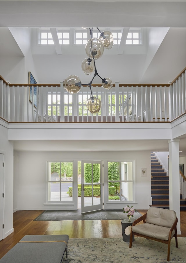 1580 Ponus Rdg, New Canaan, CT 06840 - living area featuring a chandelier, a towering ceiling, stairway, a skylight, and plenty of natural light
