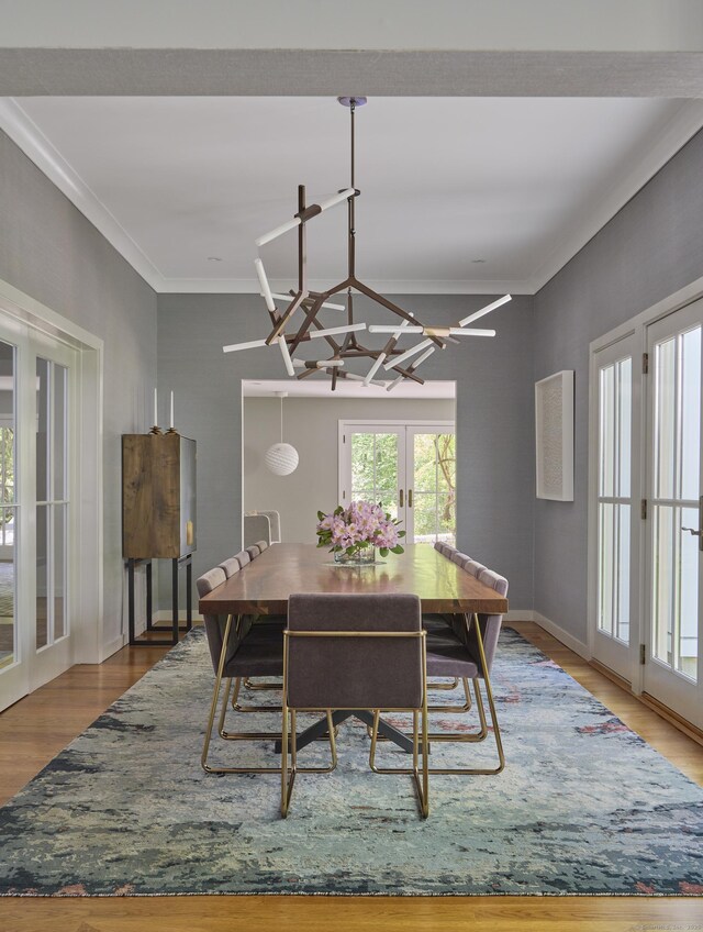 1580 Ponus Rdg, New Canaan, CT 06840 - dining room featuring french doors, wood finished floors, ornamental molding, baseboards, and a chandelier