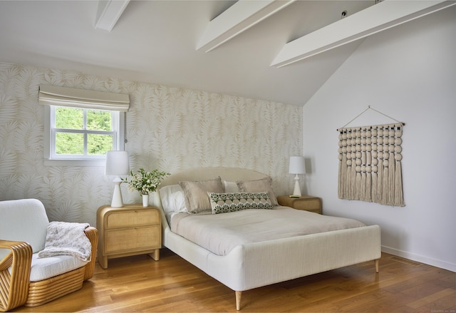 1580 Ponus Rdg, New Canaan, CT 06840 - bedroom with wallpapered walls, wood finished floors, an accent wall, baseboards, and lofted ceiling