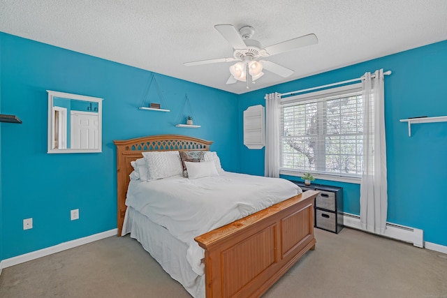 carpeted bedroom with ceiling fan, baseboards, a baseboard radiator, and a textured ceiling