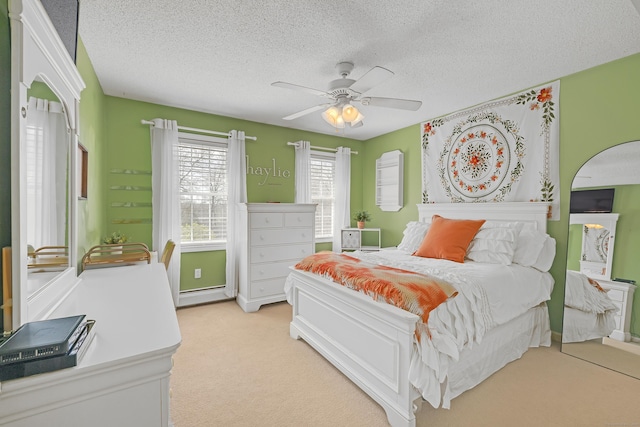 bedroom with a ceiling fan, a textured ceiling, a baseboard heating unit, and light carpet