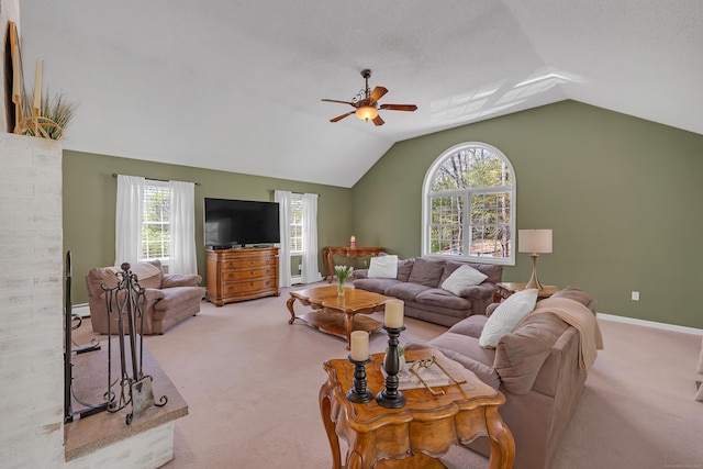 living room with carpet floors, ceiling fan, lofted ceiling, and a healthy amount of sunlight