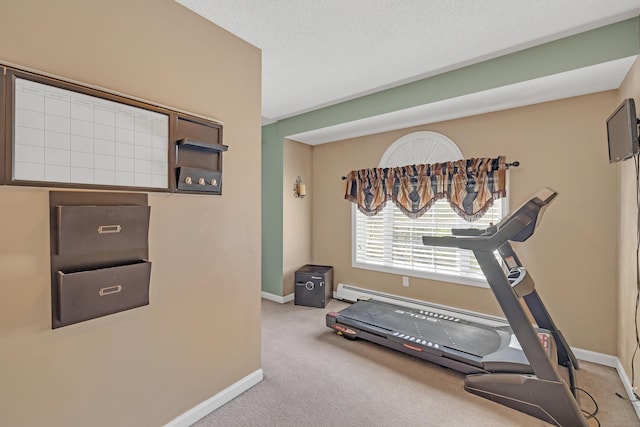 workout area featuring baseboards and carpet flooring