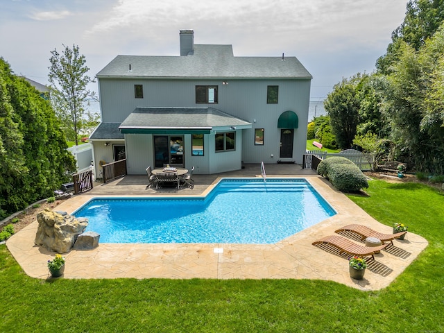 919 Pequot Ave, New London, CT 06320 - back of property with a patio area, a chimney, an outdoor pool, and roof with shingles