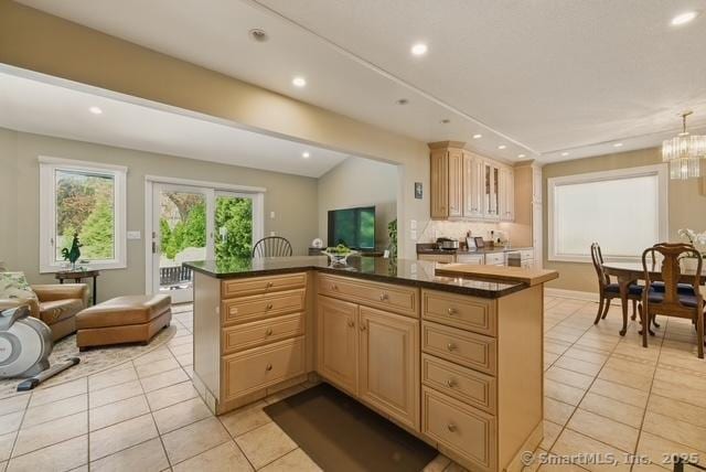 919 Pequot Ave, New London, CT 06320 - kitchen featuring light tile patterned flooring, dark countertops, recessed lighting, open floor plan, and a kitchen island