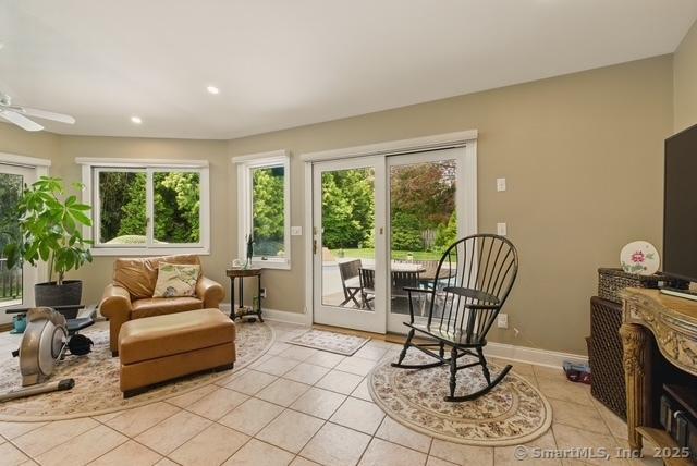 919 Pequot Ave, New London, CT 06320 - living area with healthy amount of natural light, light tile patterned floors, recessed lighting, and a ceiling fan