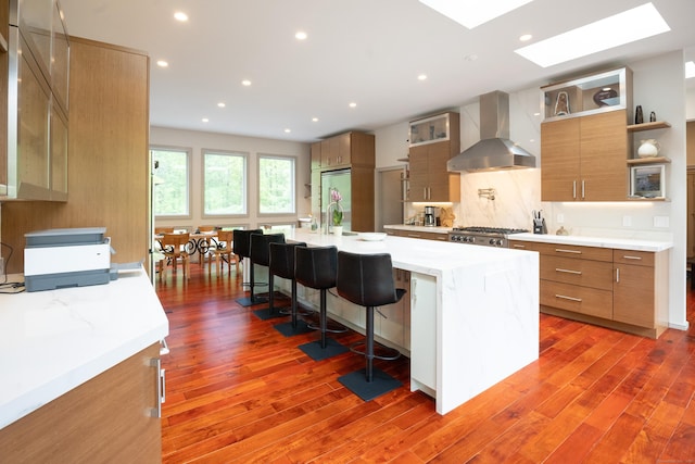 88 Green Ln, Ridgefield, CT 06877 - kitchen with wall chimney exhaust hood, light wood finished floors, a skylight, open shelves, and recessed lighting