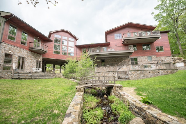 88 Green Ln, Ridgefield, CT 06877 - rear view of property featuring a balcony, stone siding, a yard, and stairs
