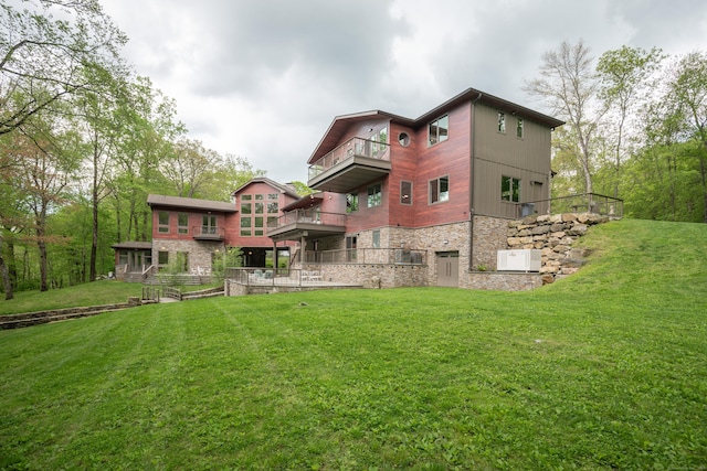 88 Green Ln, Ridgefield, CT 06877 - back of house featuring a balcony, stone siding, and a lawn