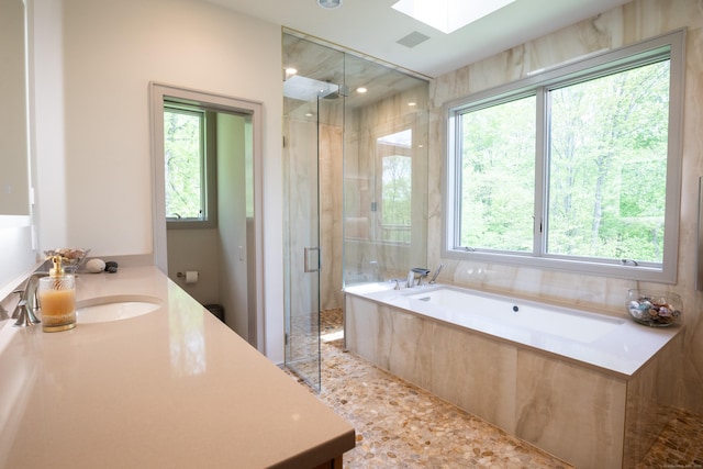 88 Green Ln, Ridgefield, CT 06877 - bathroom with vanity, a stall shower, a garden tub, and a skylight