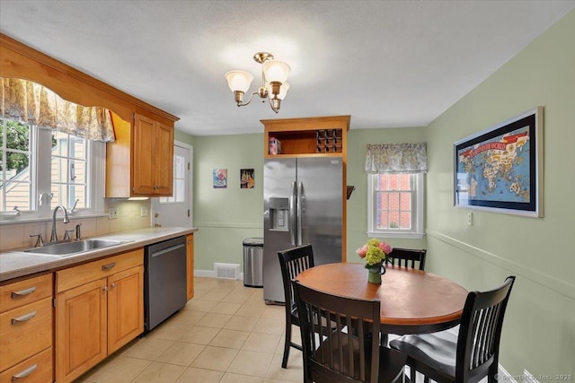 404 Brimfield Rd, Wethersfield, CT 06109 - kitchen featuring stainless steel appliances, a sink, light tile patterned floors, a chandelier, and light countertops
