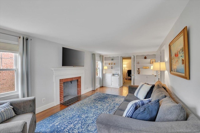404 Brimfield Rd, Wethersfield, CT 06109 - living area with wood finished floors, a brick fireplace, and baseboards