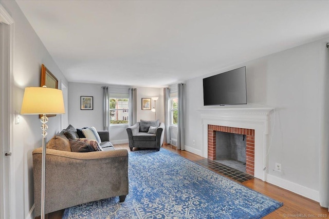 404 Brimfield Rd, Wethersfield, CT 06109 - living area featuring wood finished floors, a fireplace, and baseboards
