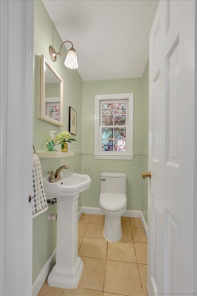 404 Brimfield Rd, Wethersfield, CT 06109 - bathroom with tile patterned flooring, toilet, baseboards, and a sink