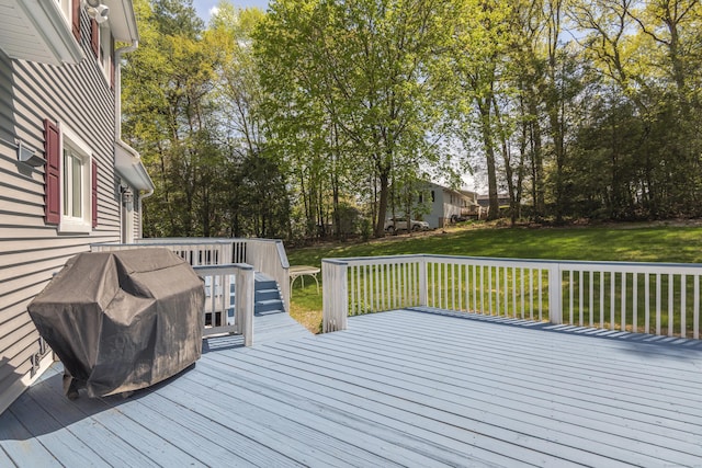 wooden terrace with a grill and a lawn