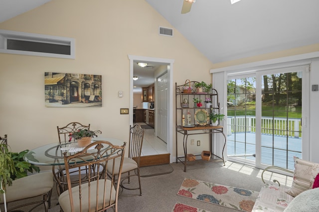 interior space with carpet, visible vents, ceiling fan, and high vaulted ceiling