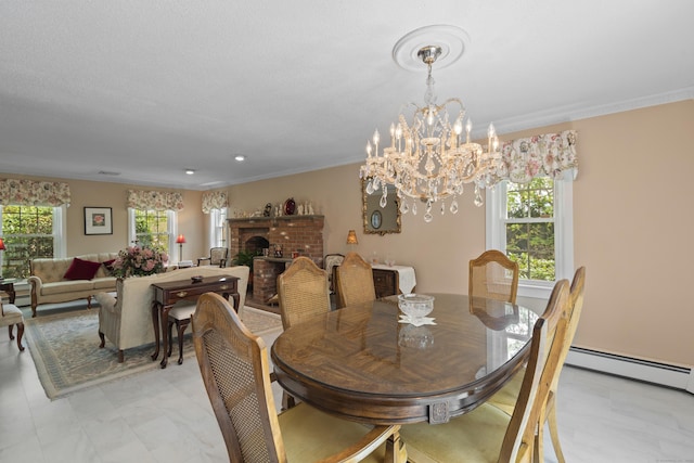dining area with a baseboard radiator, a chandelier, crown molding, and a brick fireplace