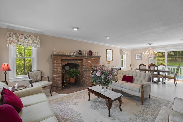 living room featuring plenty of natural light, a chandelier, a fireplace, and ornamental molding