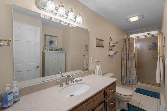 bathroom featuring a stall shower, tile patterned flooring, toilet, and vanity