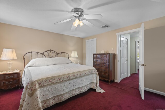 carpeted bedroom featuring visible vents, baseboards, and a ceiling fan