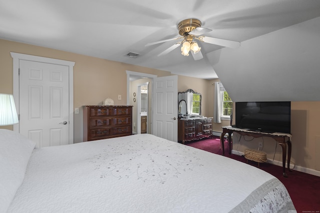 bedroom with a ceiling fan, dark carpet, visible vents, baseboards, and lofted ceiling