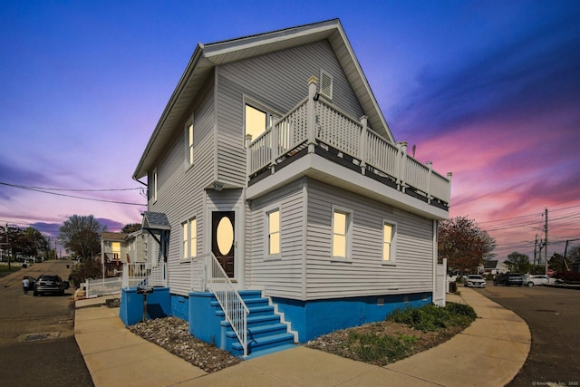 traditional-style home with a balcony and crawl space