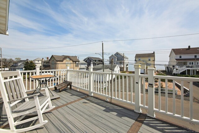 wooden terrace with a residential view