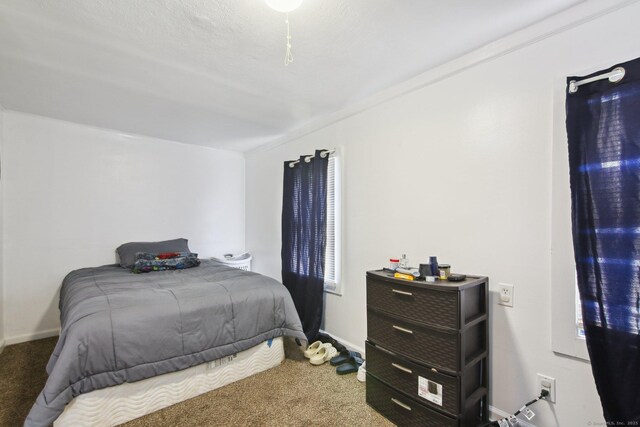 carpeted bedroom featuring baseboards