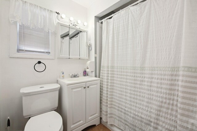 full bathroom with toilet, vanity, and a shower with shower curtain