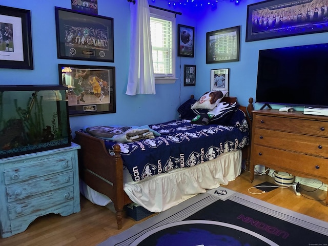 bedroom with wood finished floors