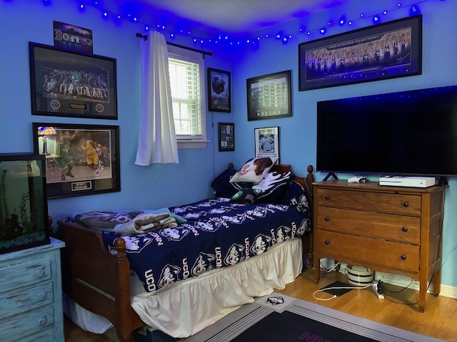 bedroom featuring wood finished floors