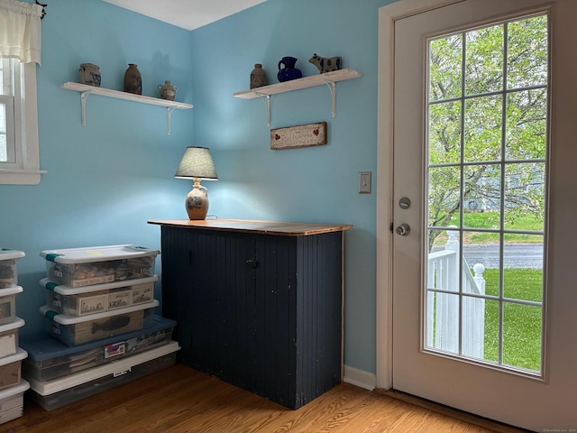 entryway with wood finished floors and baseboards