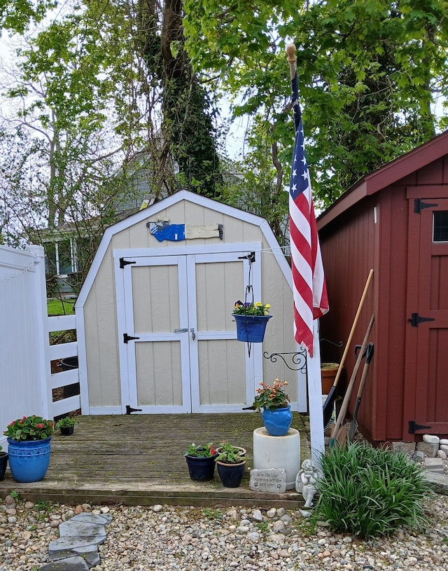 view of shed featuring fence