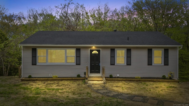 single story home with a shingled roof
