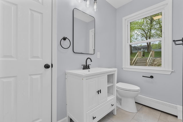 bathroom with a baseboard radiator, toilet, baseboards, tile patterned flooring, and vanity