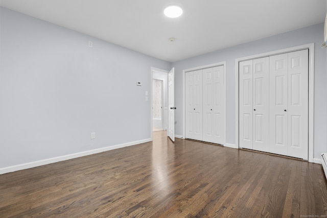 129 Benz St, Ansonia, CT 06401 - unfurnished bedroom featuring two closets, baseboards, and dark wood-style floors