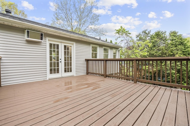 deck with french doors and a wall unit AC