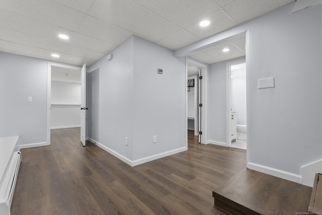 unfurnished room with baseboards, dark wood-type flooring, and recessed lighting