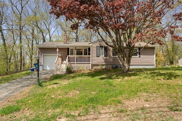 single story home with aphalt driveway, an attached garage, a chimney, and a front yard
