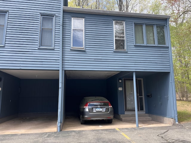 view of front of house featuring entry steps and a carport