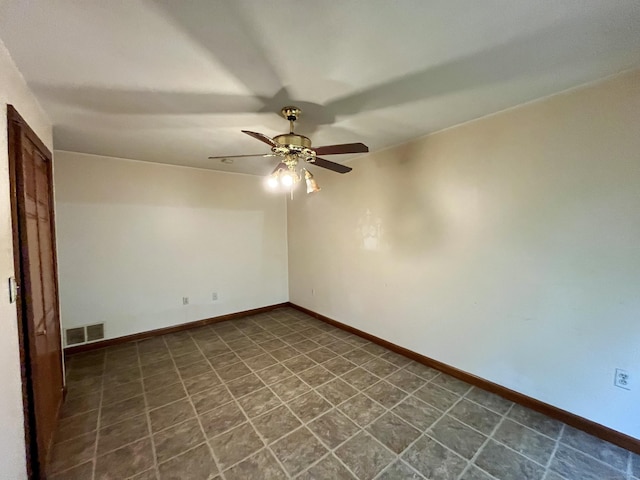 spare room featuring ceiling fan, baseboards, and visible vents