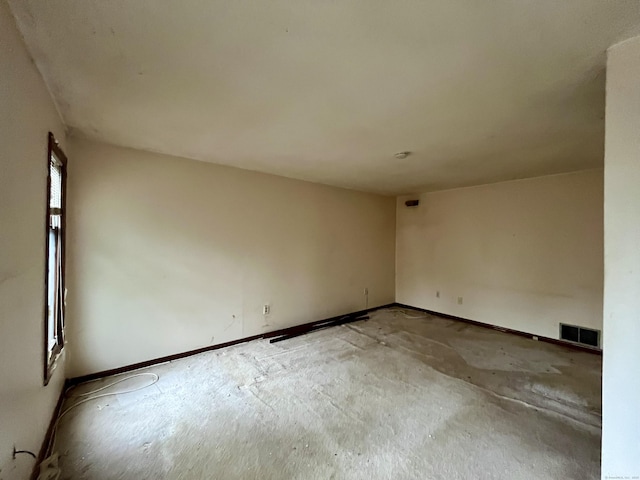 spare room featuring baseboards and visible vents