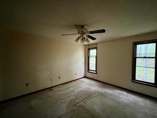 unfurnished room with baseboards and a ceiling fan