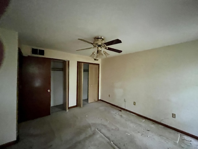 unfurnished bedroom featuring ceiling fan, baseboards, multiple closets, and visible vents