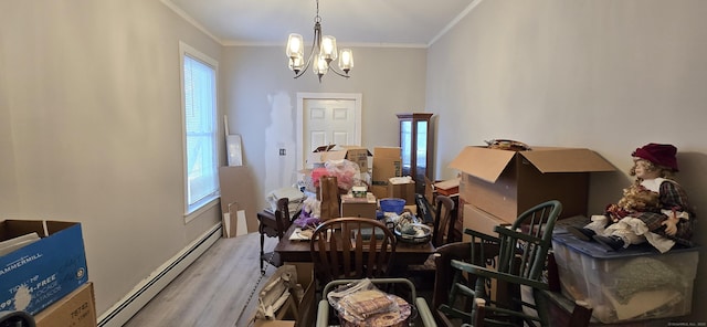 dining space with ornamental molding, baseboard heating, and a notable chandelier