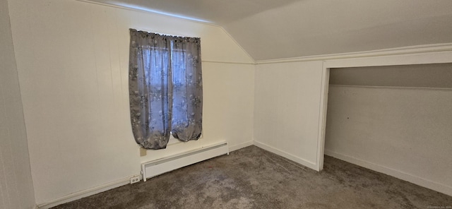 unfurnished bedroom featuring carpet floors, baseboards, vaulted ceiling, and a baseboard radiator
