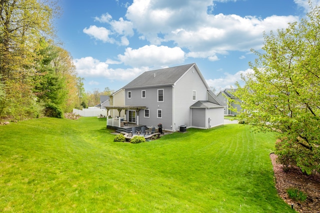 rear view of property with fence, roof with shingles, a pergola, a patio, and a yard