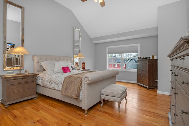 bedroom with a ceiling fan, baseboards, light wood-style flooring, and lofted ceiling